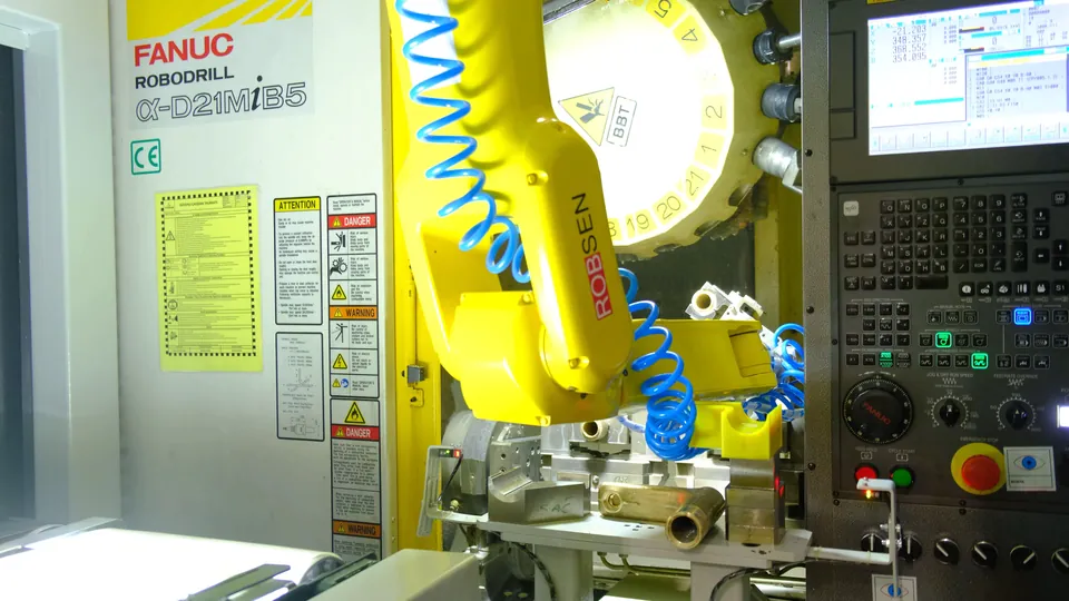 The robot loads a part into the machine vise