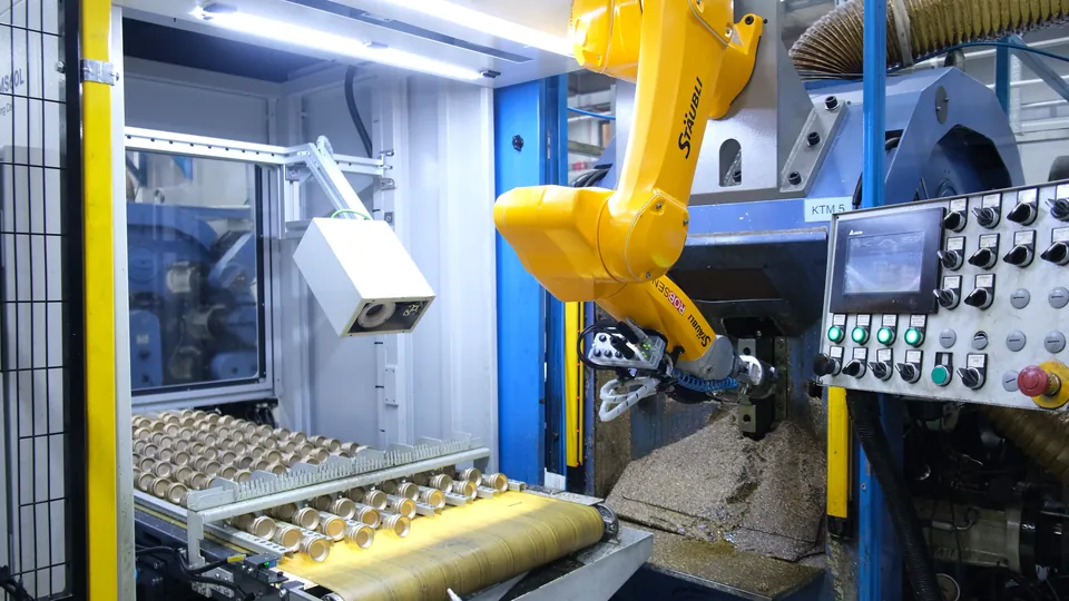 The robot loads the part into the transfer machine