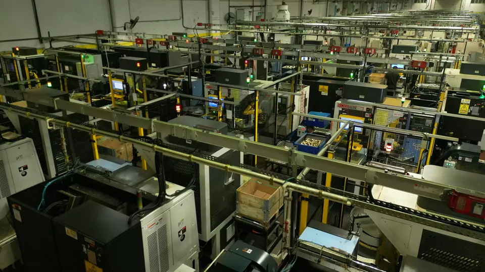 A hall of lathes, each with its own cell